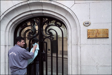 Here an employee of the Buenos Aires Jockey Club, the governing body of the Argentine Turf Association, is polishing the glass at the entrance.