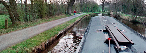 Narrowboat. Paula walks ahead.