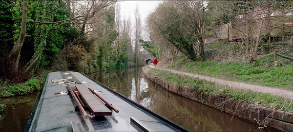 Narrowboat. Paula walks around the bend.