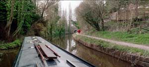 Narrowboat. Paula walks around the bend.